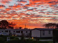 A brilliant sunset over the static caravans at Looe Country Park