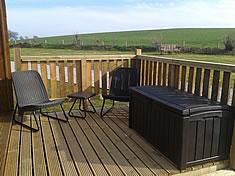 Camping pod decking area with wet clothes storage box